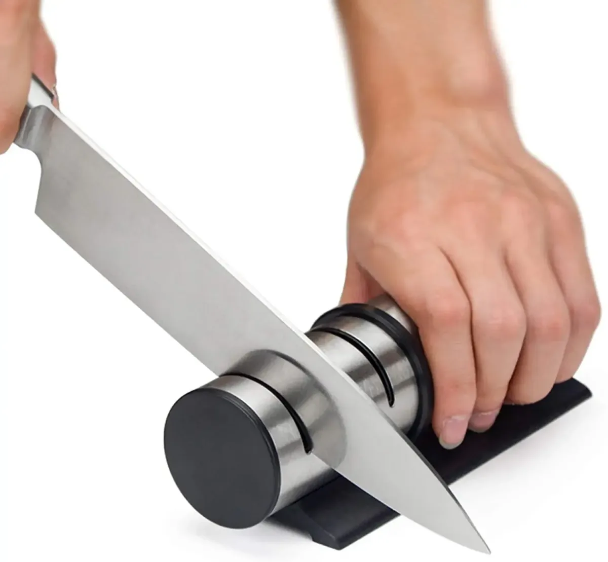 hand holding the stainless steel knife sharpener while a knife is pulled through