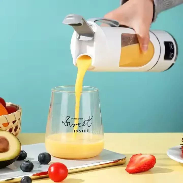 pouring orange juice from the portable juice blender cup